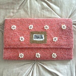 NWOT “Press for Champagne” pink beaded clutch